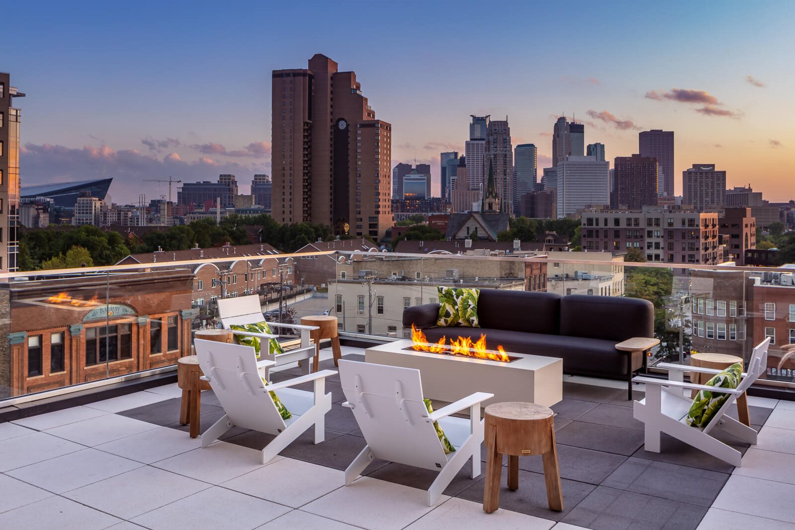 Rooftop fire pit with seating overlooking Minneapolis skyline